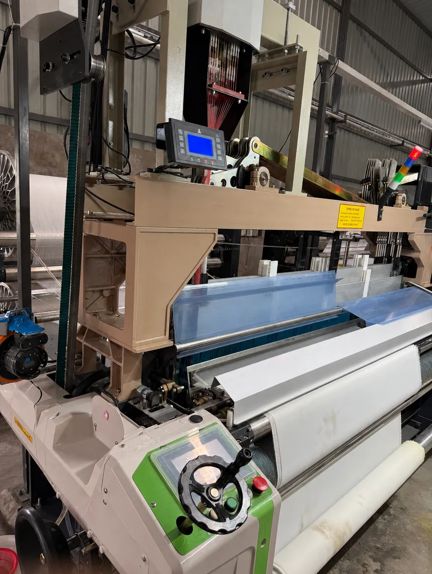 Close-up of the reed and beam of a water jet loom
